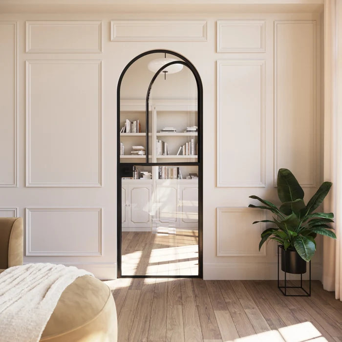 Solid steel Dutch door with full arch top and modular construction.