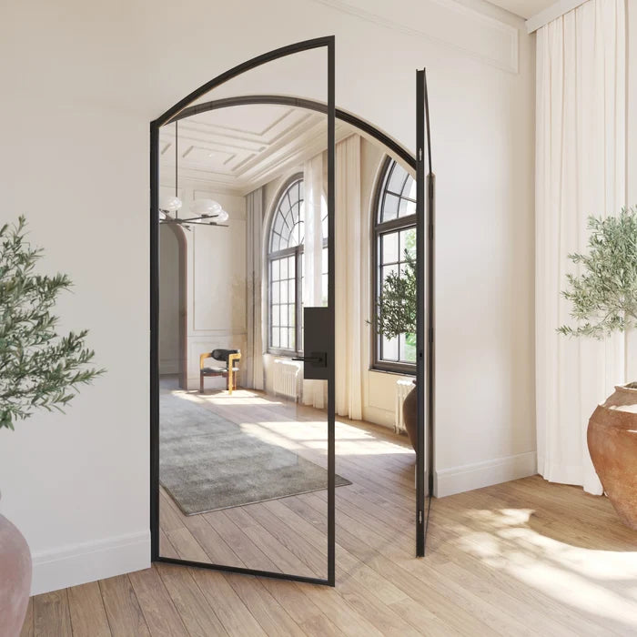 Solid steel double door with curved tops and architectural proportions.