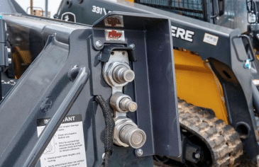 John Deere G Series skid steer with coupler guard installed, showing the quick-attach coupler area
