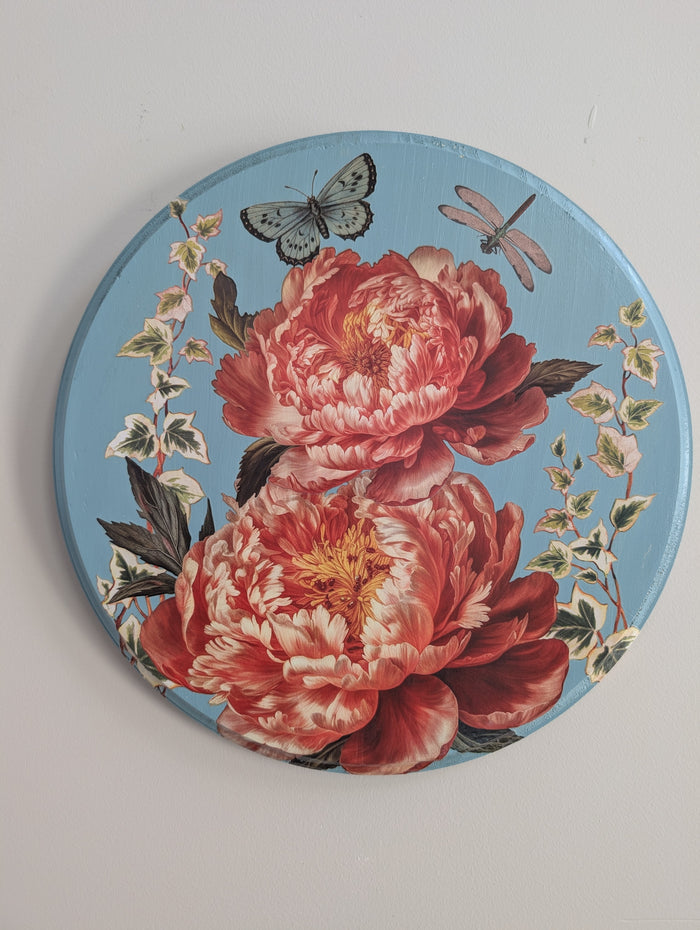 Decorative plate with floral design and butterflies on a light gray background