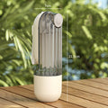 The Green Portable Dog Water Bottle standing upright during a sunny outdoor pet walking break