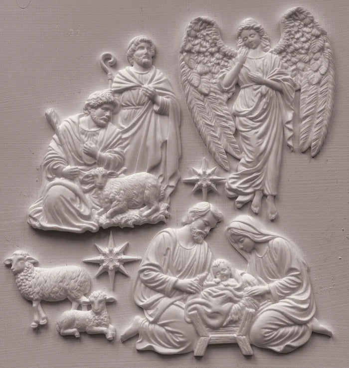 White relief wall plaque featuring a nativity scene with Mary, Joseph, baby Jesus, angels, and sheep, shown against a matching light gray textured background.