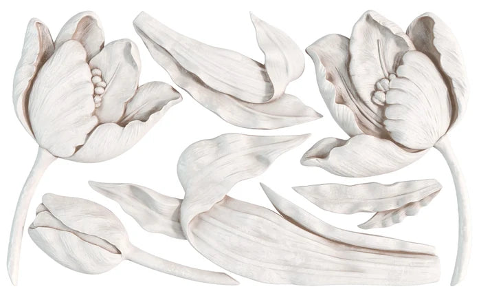 Decorative wall art with floral designs in white on a white background